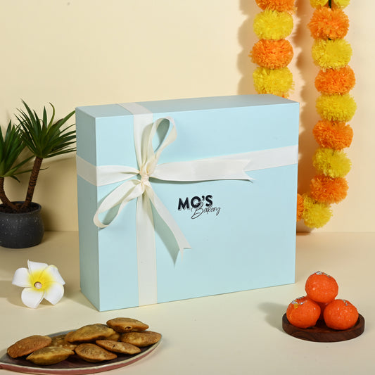 Mo’s Blue Gift Box Raspberry & apple cinnemon  Cookies – 2 Cookies, 4 Diyas, 2 Coasters, Roli Tikka Chawal Set & Potli Pouches